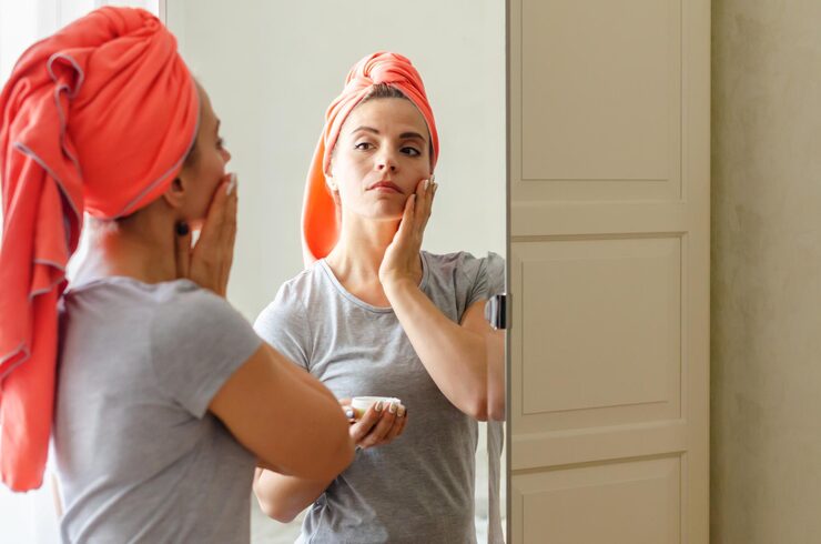 middleaged-woman-doing-face-building-exercises-home-massaging-her-face-beauty-routine-spa-wellness-skincare-female-doing-routine-self-care-mirror-taking-care-facial-skin-by-massage_534631-748